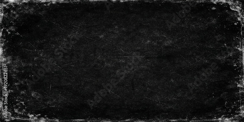 Empty dark black and white grunge chalkboard background with a vintage textured grey stone wall pattern and blank dirty paper surface for a moody design backdrop