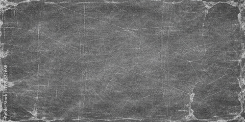 A dark vintage grunge background featuring a distressed black and grey paper texture with an old dirty stone wall pattern for a textured concrete surface backdrop design