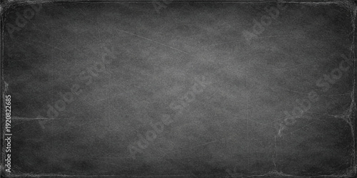A dark and weathered black chalkboard background features an old grunge texture on a dirty stone surface, creating a blank vintage wallpaper design for a textured backdrop or frame