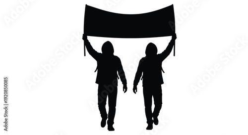 Two people holding a banner in a dark striking silhouette