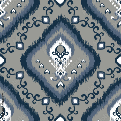 Seamless ikat pattern with diamond medallion motifs in navy, gray, and white tones. Ethnic woven textile inspired background, ideal for fabric, fashion, wallpaper, upholstery, and boho surface design.