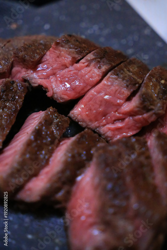 Juicy medium rare beef steak sliced close up on plate