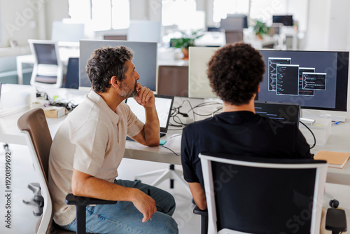 Software developers team working on project using computer in office