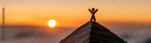 Wallpaper Mural Wooden figurine stands on peak at sunrise symbolizing success in business goal achievement with uplifting and inspiring atmosphere Torontodigital.ca