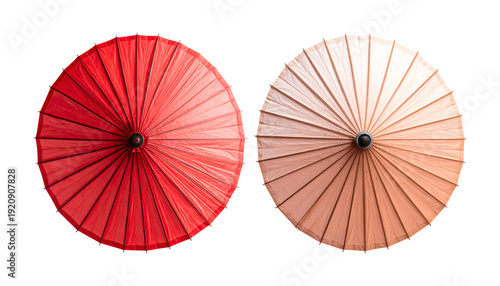 Two traditional asian oil paper umbrellas one vibrant red and one soft beige shown from a top down perspective  
