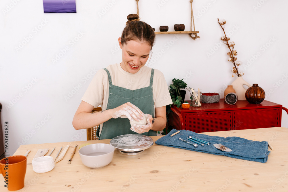 © Tania Cervian/Stocksy - Happy young female artisan making ceramics at home