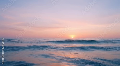 Beautiful tranquil sunset over the ocean with soft pastel colors painting sky