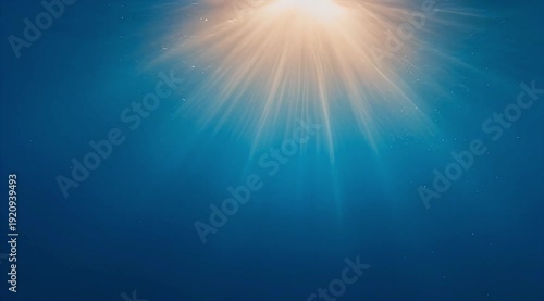 Sunlight streaming through the ocean's surface creates a beautiful blue scene