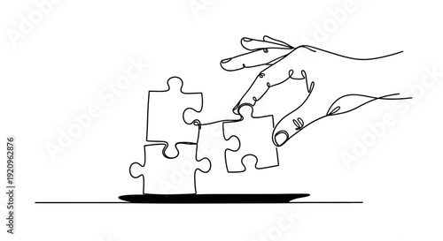 Hand placing last puzzle piece to complete team or project, symbolizing connection