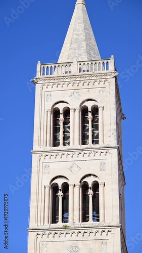 Romanesque bell tower of St. Anastasia's Cathedral in Zadar against a clear blue sky. Croatia