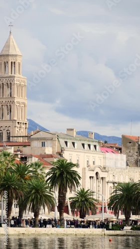 Split Riva waterfront featuring historic architecture, palm trees, and people by the sea