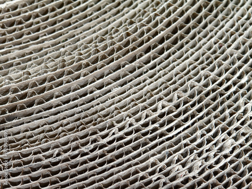 Macro Texture of Corrugated Cardboard Sheets Layered Background. packaging materials, recycling industries, sustainable shipping solutions, and textured surfaces for creative graphic design.