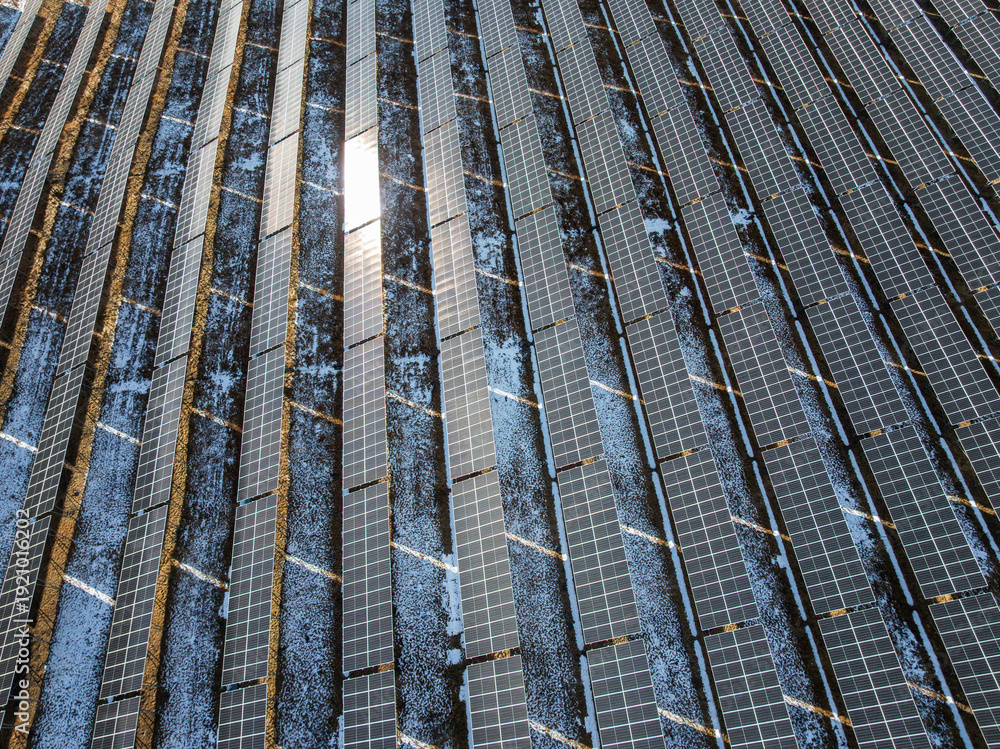 Obraz premium Close-up of Solar Panel Arrays Covered in Snow, Photovoltaic Power Station on High Altitude Plateau, Renewable Energy