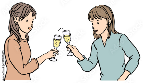 シャンパンで乾杯する若い2人の女性