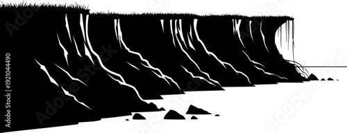 Coastal cliff face silhouette with grassy top and sea rocks