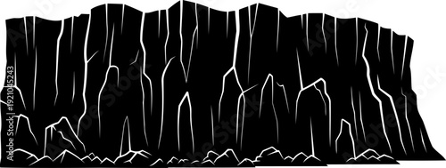 High cliff face silhouette with vertical rock formations and boulders