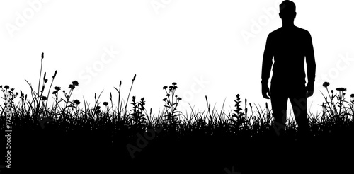 Man standing in a wildflower meadow silhouette under a clear sky