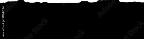 Rugged mountain range horizon silhouette against a clear sky