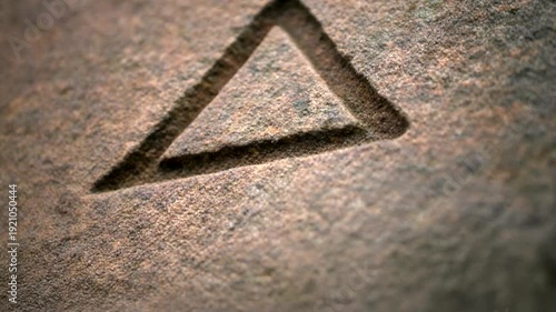 Triangle Symbol Etched into Stone Surface.