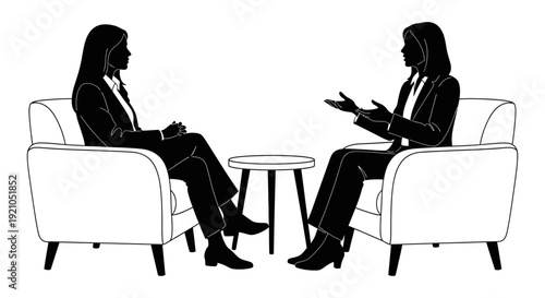 two businesswomen having a professional discussion in armchairs illustrating corporate communication collaboration and active listening.