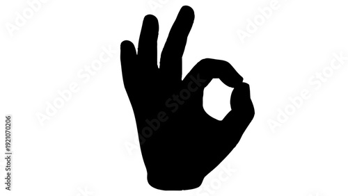 a black hand silhouette making an ok gesture isolated on a white background symbolizing approval perfection and success.