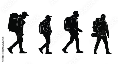 Silhouettes of hikers walking in a line carrying large backpacks