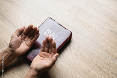 Wallpaper Mural Old man hands clasped prayer with Holy Bible for Christian faith, spirituality, worship, devotion, hope, and religious belief, prayer time in church, trust in God, and spiritual guidance. Torontodigital.ca