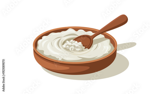 A bowl of yogurt with a spoon is placed on a white surface.