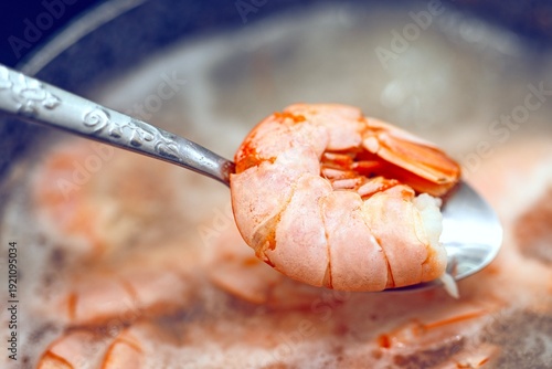 Wallpaper Mural Large red langoustine on a metal spoon lifted from a pot of boiling water with shrimp. Seafood cooking process. Torontodigital.ca