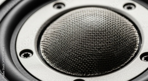 Close-up of a high-fidelity audio speaker tweeter cone with metal grille
