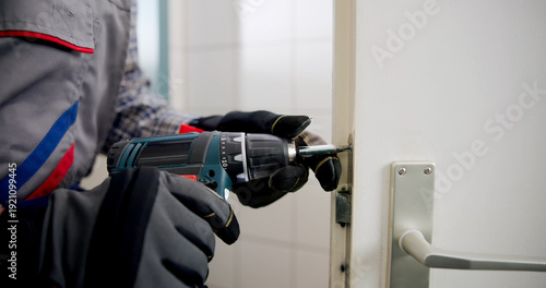 Bild auf Leinwand The Experienced Locksmith Expertly Replacing A Damaged Door
