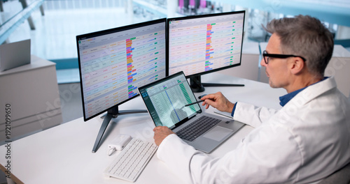 Male Doctor Managing Billing Codes In Hospital