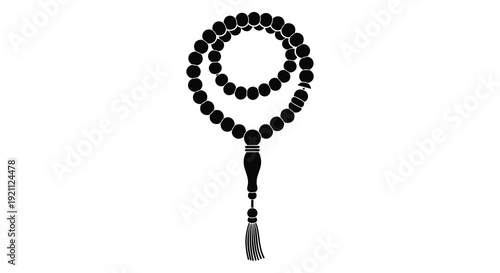 A black beaded necklace with a tassel hangs against a white background providing a striking silhouette high quality