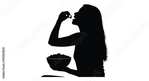 A dark silhouette of a woman thoughtfully feeding herself from a bowl of food presenting a simple scene silhouette