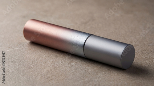 A tube of mascara on a brown background