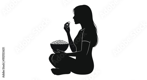 A striking black silhouette depicts a woman seated and enjoying a bowl of popcorn a cozy scene silhouette