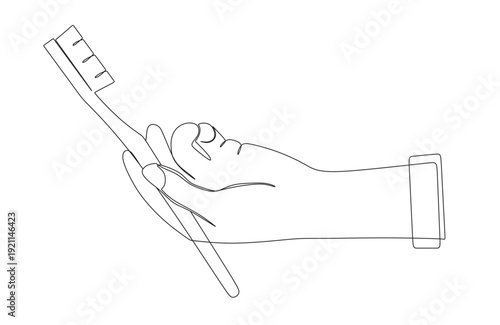 continuous line art of a hand holding a toothbrush. This image is to commemorate international oral health day.
