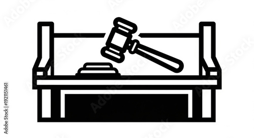 Judge's gavel resting on a wooden bench in a courtroom scene from a side view
