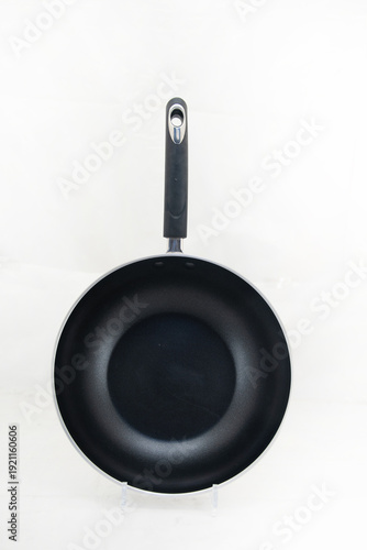 Vászonkép Top view of black nonstick frying pan isolated on white background, modern kitchen utensil product photography