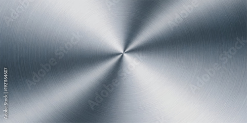 A polished silver stainless steel plate features a brushed metal texture and a smooth industrial aluminum surface with a shiny gray metallic pattern and light reflections on the material