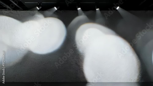 Textured wall illuminated by stage spotlights creating abstract light patterns