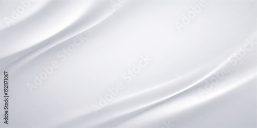 A serene high-angle shot of a minimalist modern living room featuring a plush grey sofa and natural wooden accents bathed in soft morning sunlight