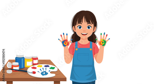 Excited young girl wearing a blue apron showing her hands covered in vibrant colorful paint in a creative art studio.