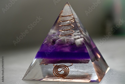 High resolution color image of a Large Handmade Orgonite Pyramid with Amethyst Crystals – Symmetrical Copper Design on White Marble Background