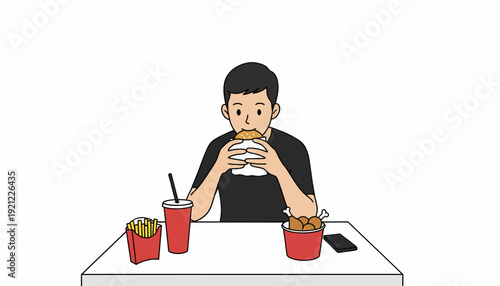 Man eating burger and fries at a table with a drink and phone nearby in a casual dining setting from a front view
