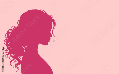 Elegant silhouette of a beautiful woman with curly hair in profile view.