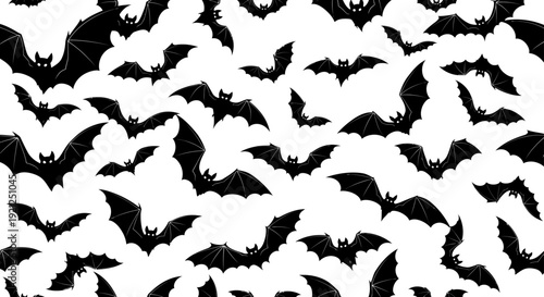 seamless halloween pattern of spooky flying black bat silhouettes on a white background ideal for textile designs party invitations and web backgrounds.