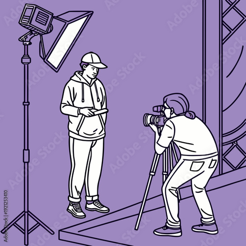 Photographer capturing a model in a studio setting with professional lighting.