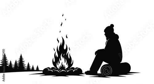 A person sits by a campfire in a stark black silhouette