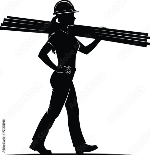 Construction worker carrying a bundle of lumber